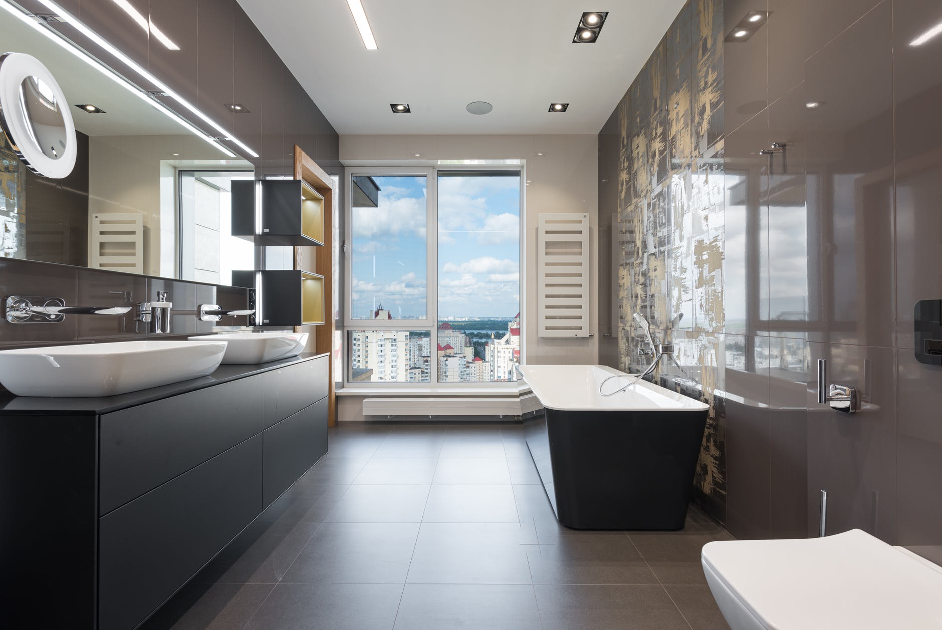 interior of modern bathroom with bathtub and big windows